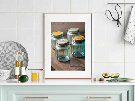 Trio of vintage blue mason jars placed on a marble kitchen countertop